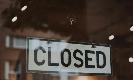 Closed sign hanging in a shop window