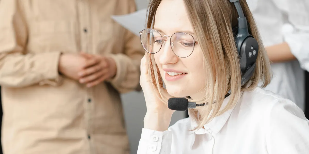 Smiling woman wearing a headset working in customer support